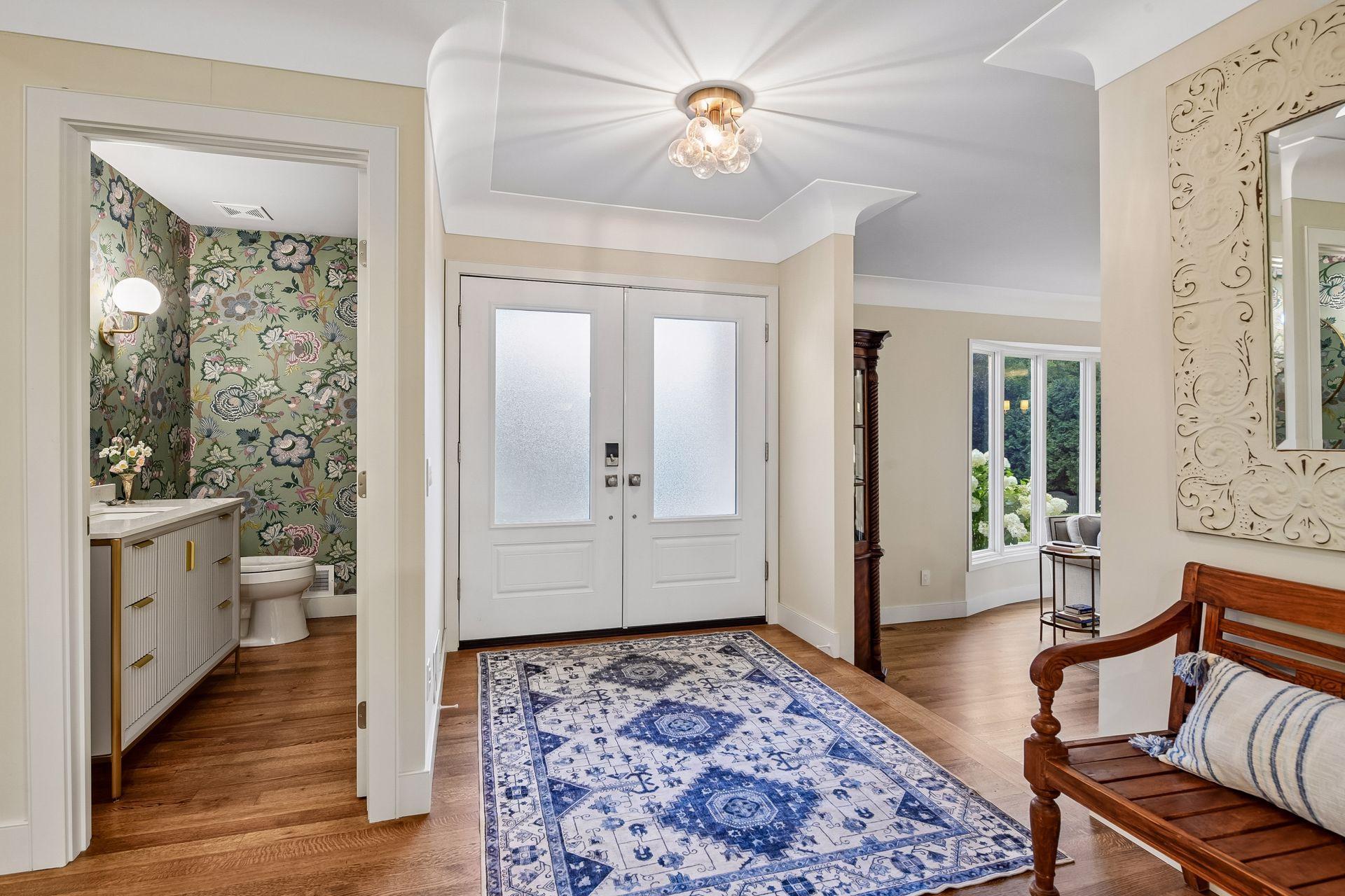 Welcoming entry with updated doors, lighting, and hardwood floors