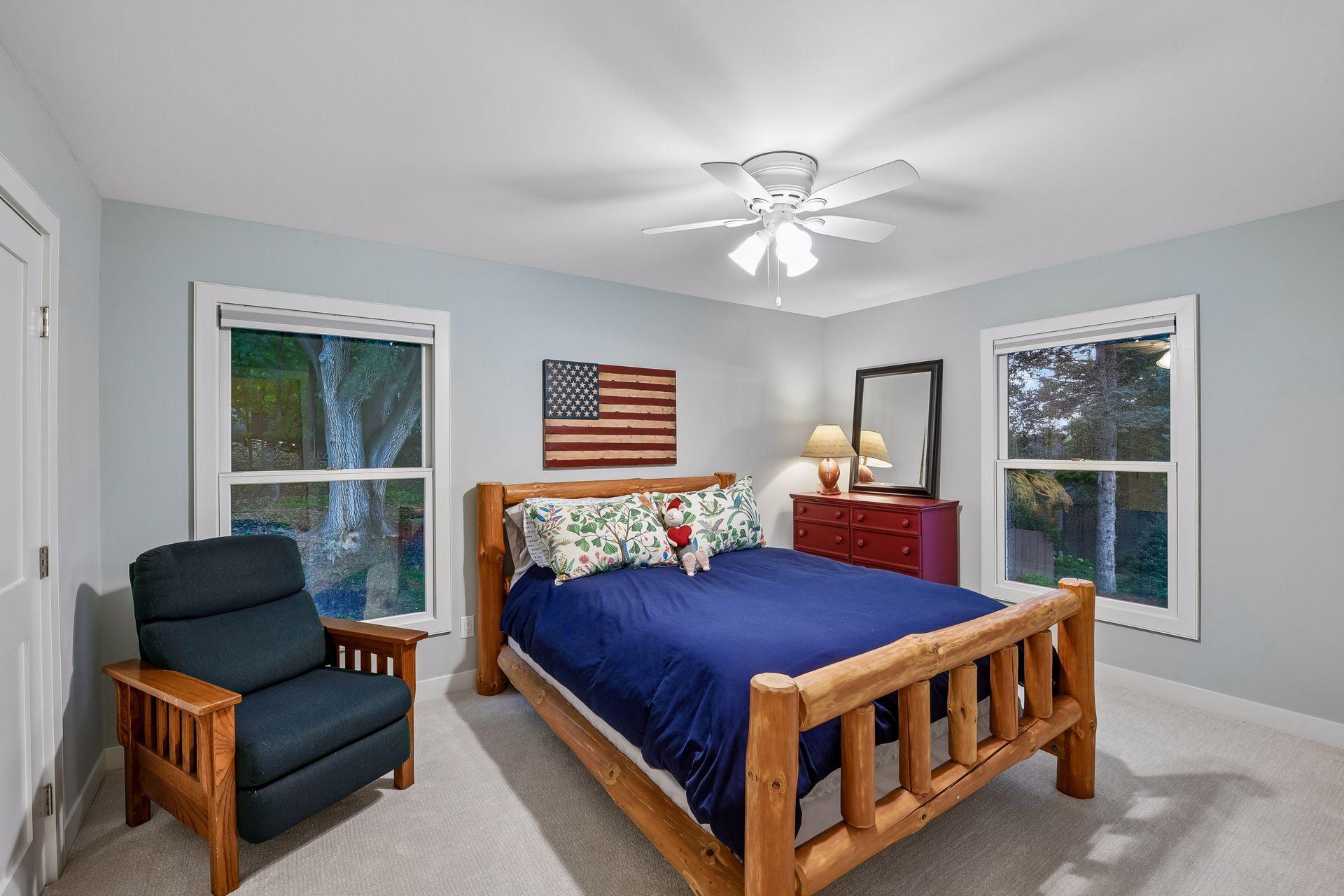 Bright additional bedroom features new carpet, lighting, and paint