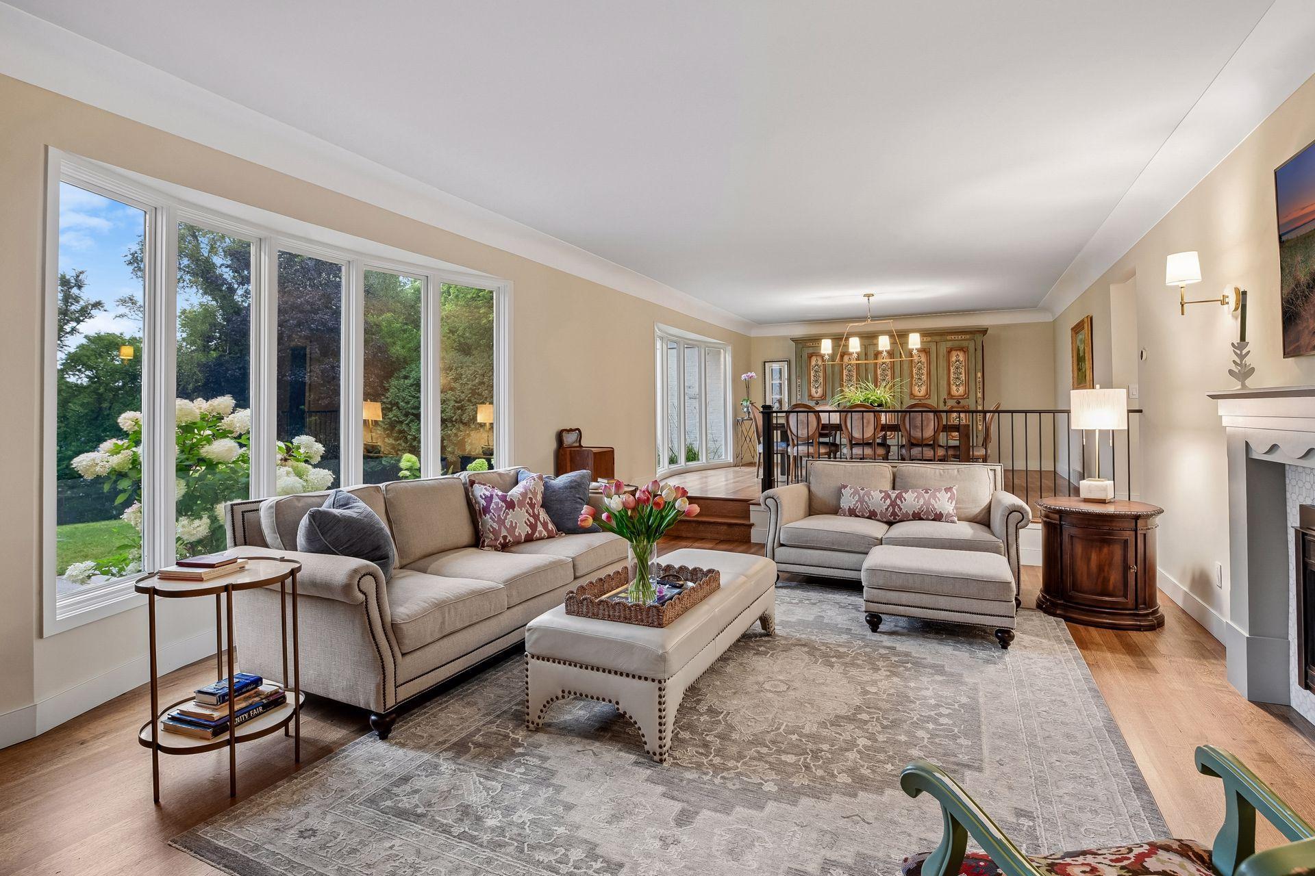 Bright, spacious living room showcases beautiful hardwood floors