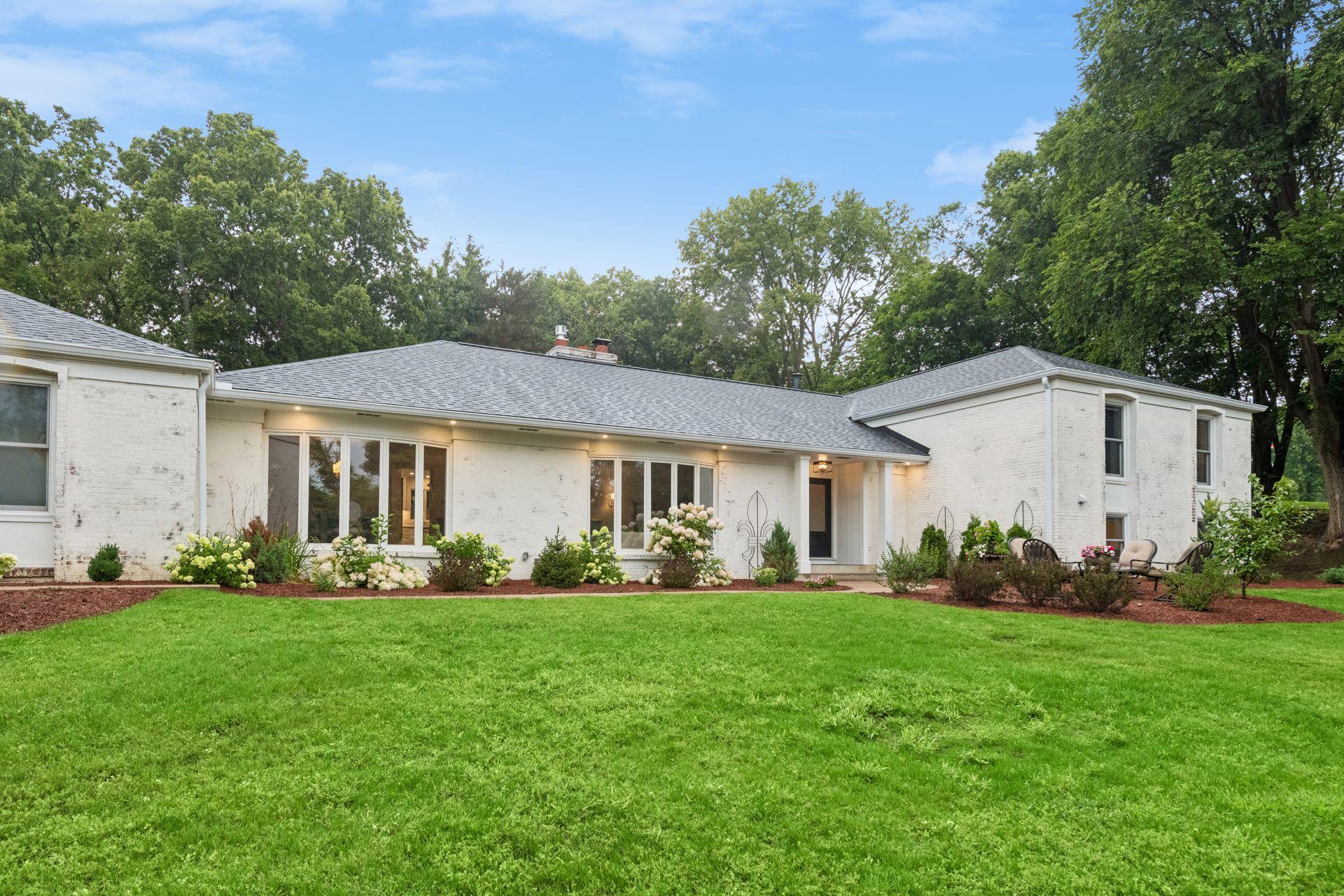 Fresh exterior paint complements the beautifully renewed landscaping