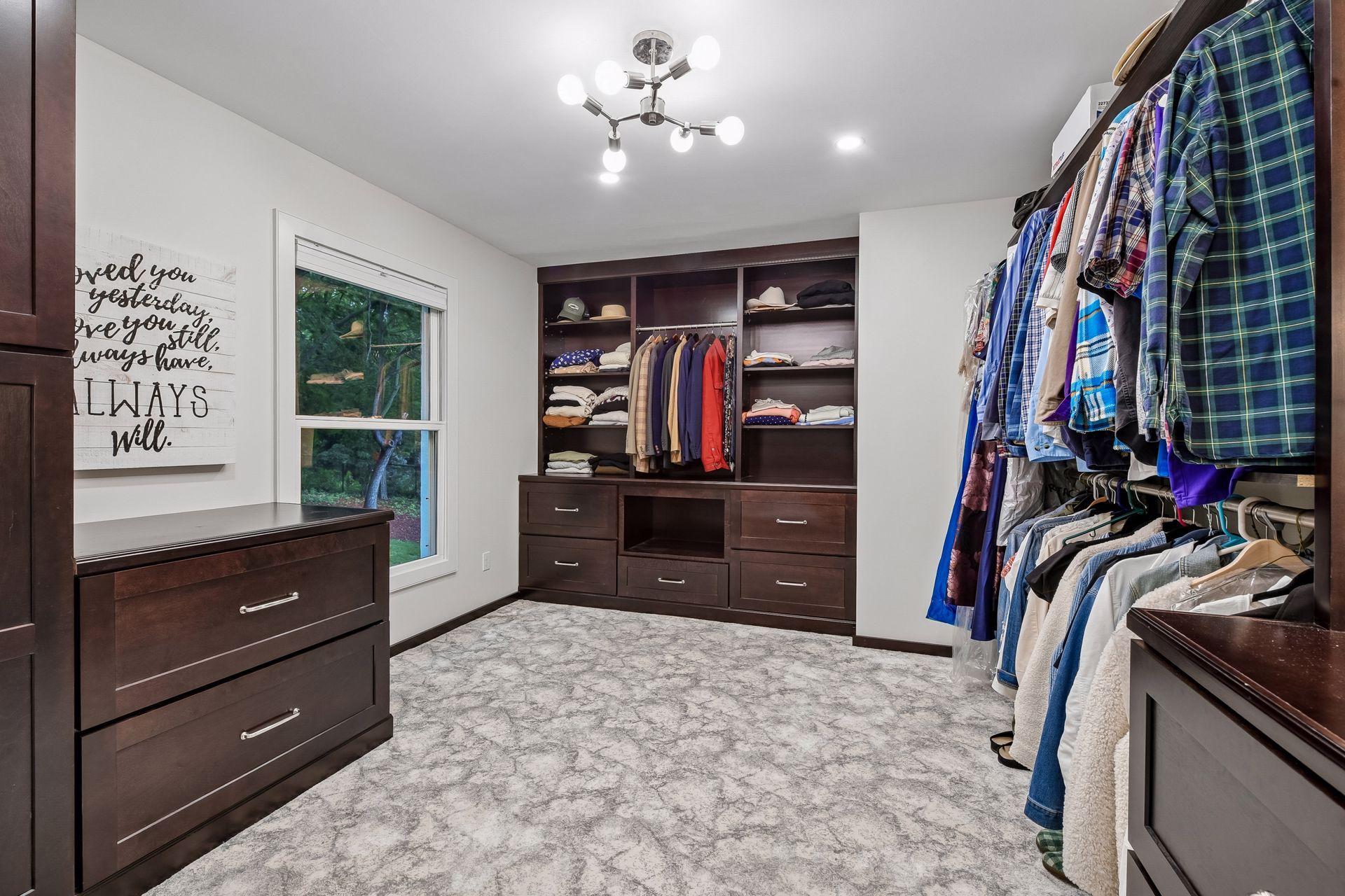 Custom walk-in closet offers beautiful built-in cabinetry and storage