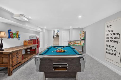 A second amusement room is fully below grade along with an exercise space, a second laundry and plenty of storage space.