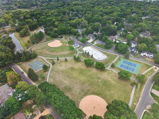 An overhead view of the park with tennis courts, a hockey rink, and a basketball court.