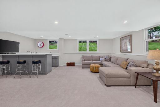 The lower level amusment area also is equipped with a wet bar. AI enhanced grass in the background