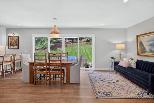 Informal dining/sitting area opens to a spacious patio with AI enhanced grass