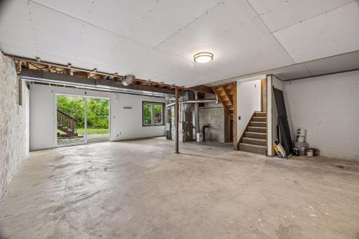 unfinished basement walks out to a lower level patio