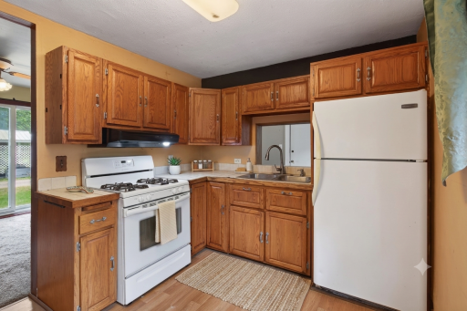 Kitchen countertops virtually staged with a towel, plant, spice rack and soap dispenser
