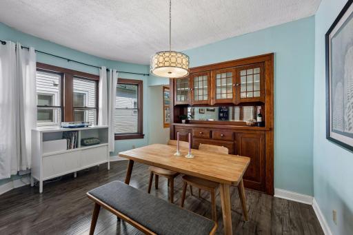 Multiple windows bring wonderful natural light into the dining room, creating a bright and welcoming space for everyday meals or entertaining.