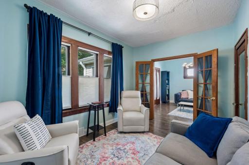 The main-level residence offers three bedrooms, including this flexible space currently used as a cozy sitting room.