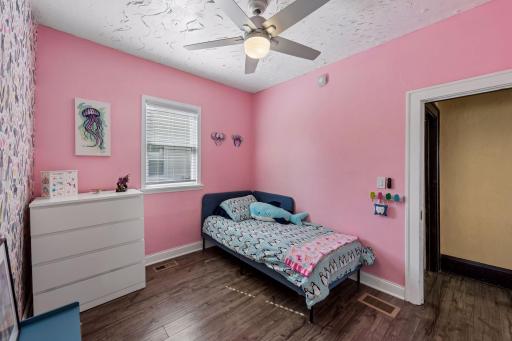 A cheerful third bedroom offers flexible space for family, guests or a home office.