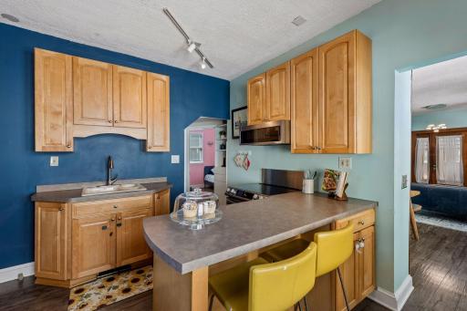 Bright, functional kitchen with newer appliances, including an induction range, plus abundant cabinetry and a convenient breakfast bar.