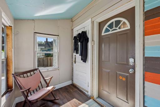 This enclosed entry creates a practical transition space with separate doors to the main-level home and upper apartment.