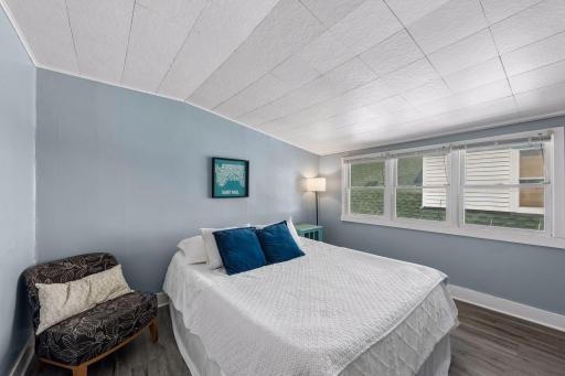 The apartment bedroom is surprisingly spacious, with a wall of windows bringing in plenty of natural light.