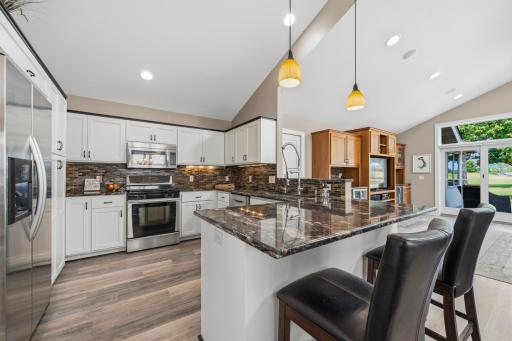 The beautifully appointed kitchen features granite countertops, ample seating, and a layout made for gathering.