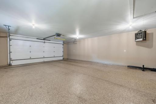 The oversized heated garage offers plenty of room for vehicles, storage, and hobbies.