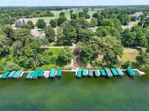 A bird's-eye view showcases the home's incredible proximity to both the golf course and the lake.