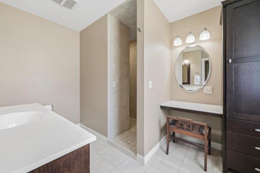 The spacious bath also features a large vanity for easy storage and a makeup vanity.
