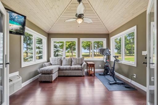 The inviting porch off the primary suite is the perfect place to unwind while enjoying panoramic golf course views.