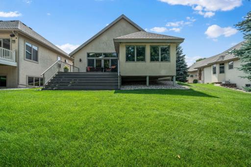 Another view highlights the beautifully maintained backyard and deck.