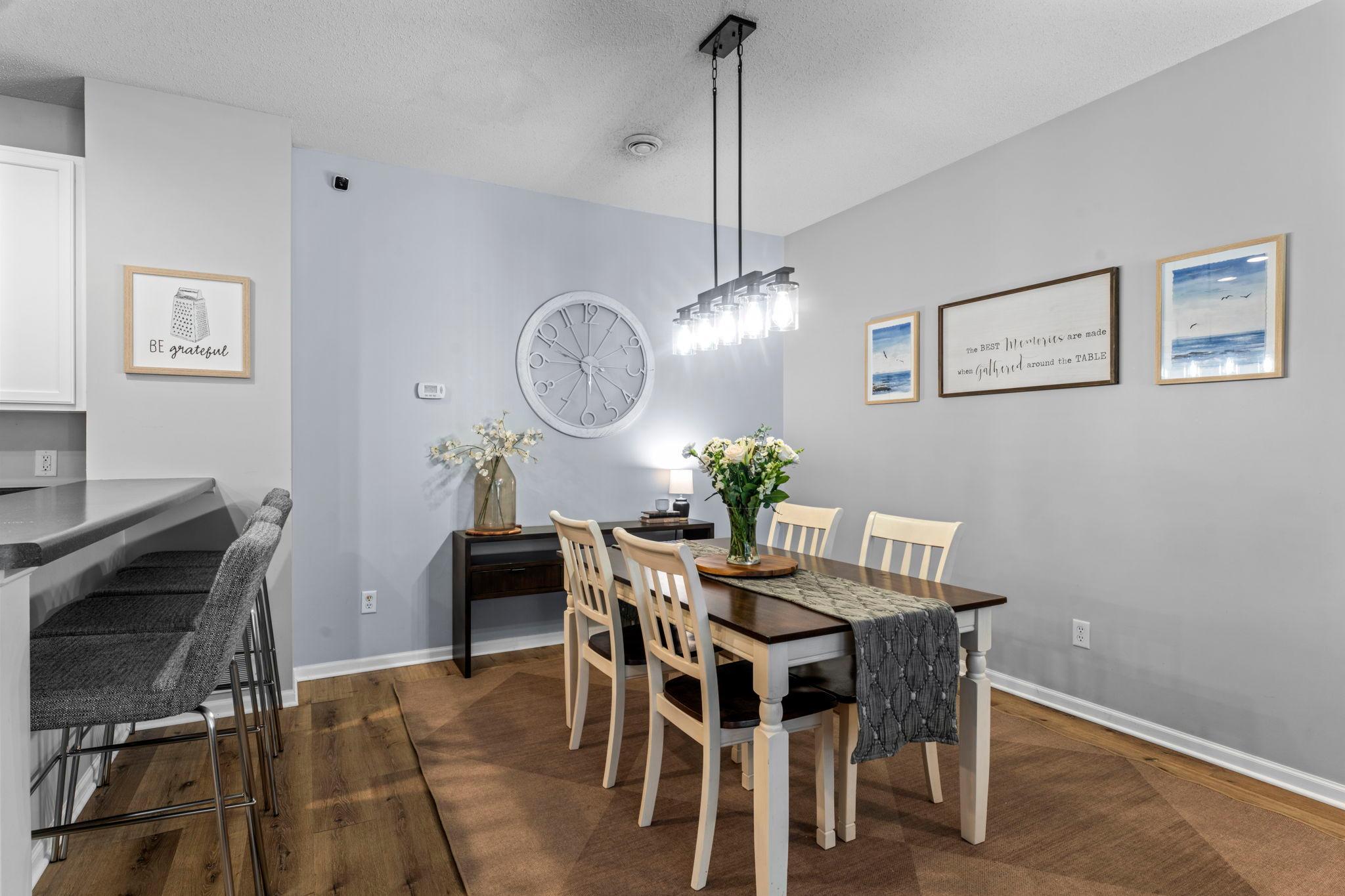 Statement lighting helps define the adjacent dining area, adding personality.