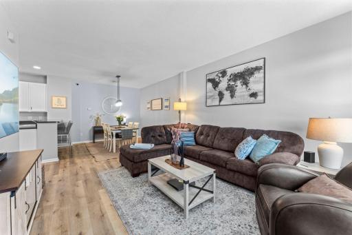 The spacious living room makes a welcoming first impression with updated laminate flooring (2025).