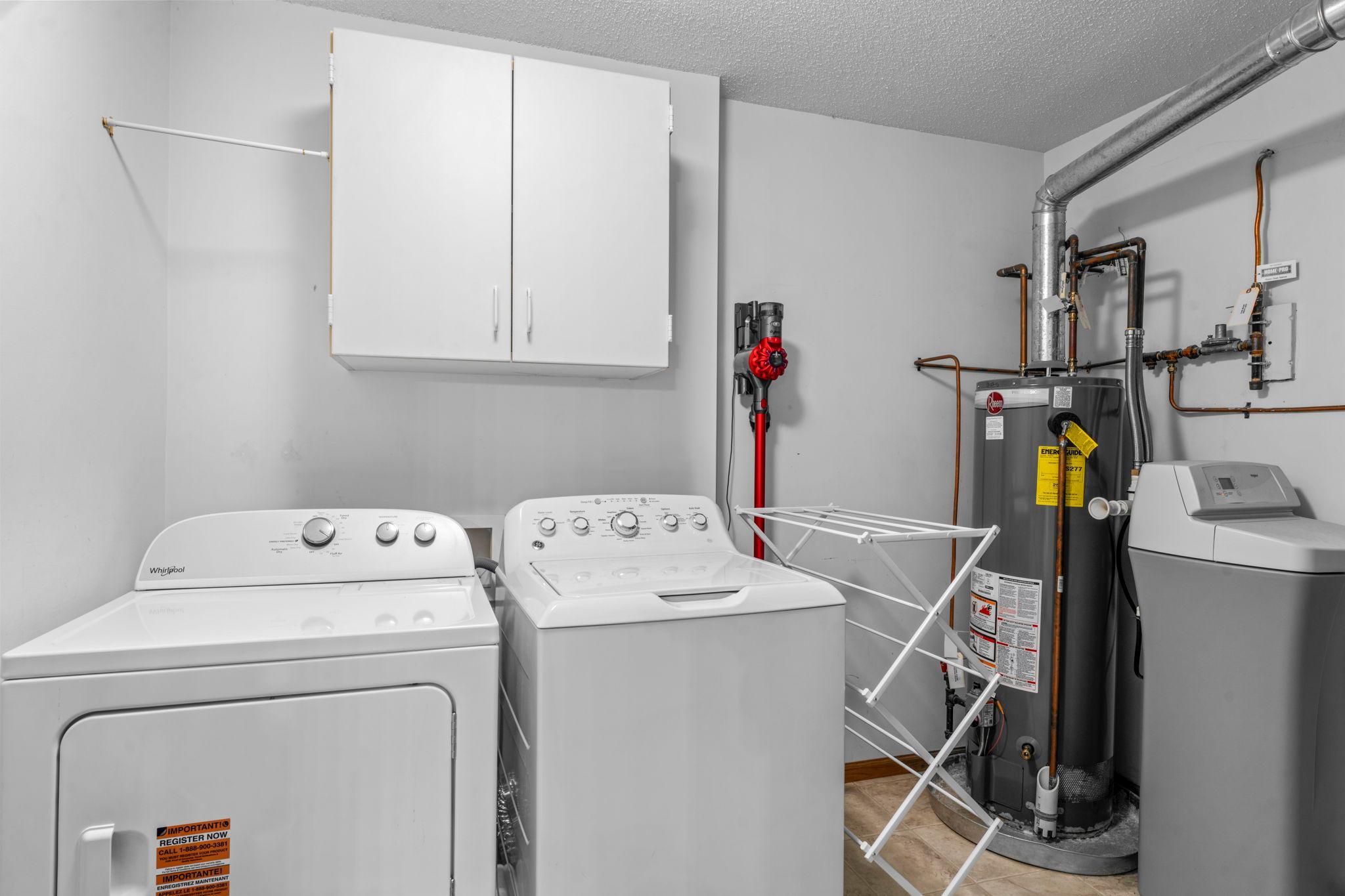 The upper-level laundry area keeps routines conveniently close to the bedrooms, with a new dryer added in 2025.