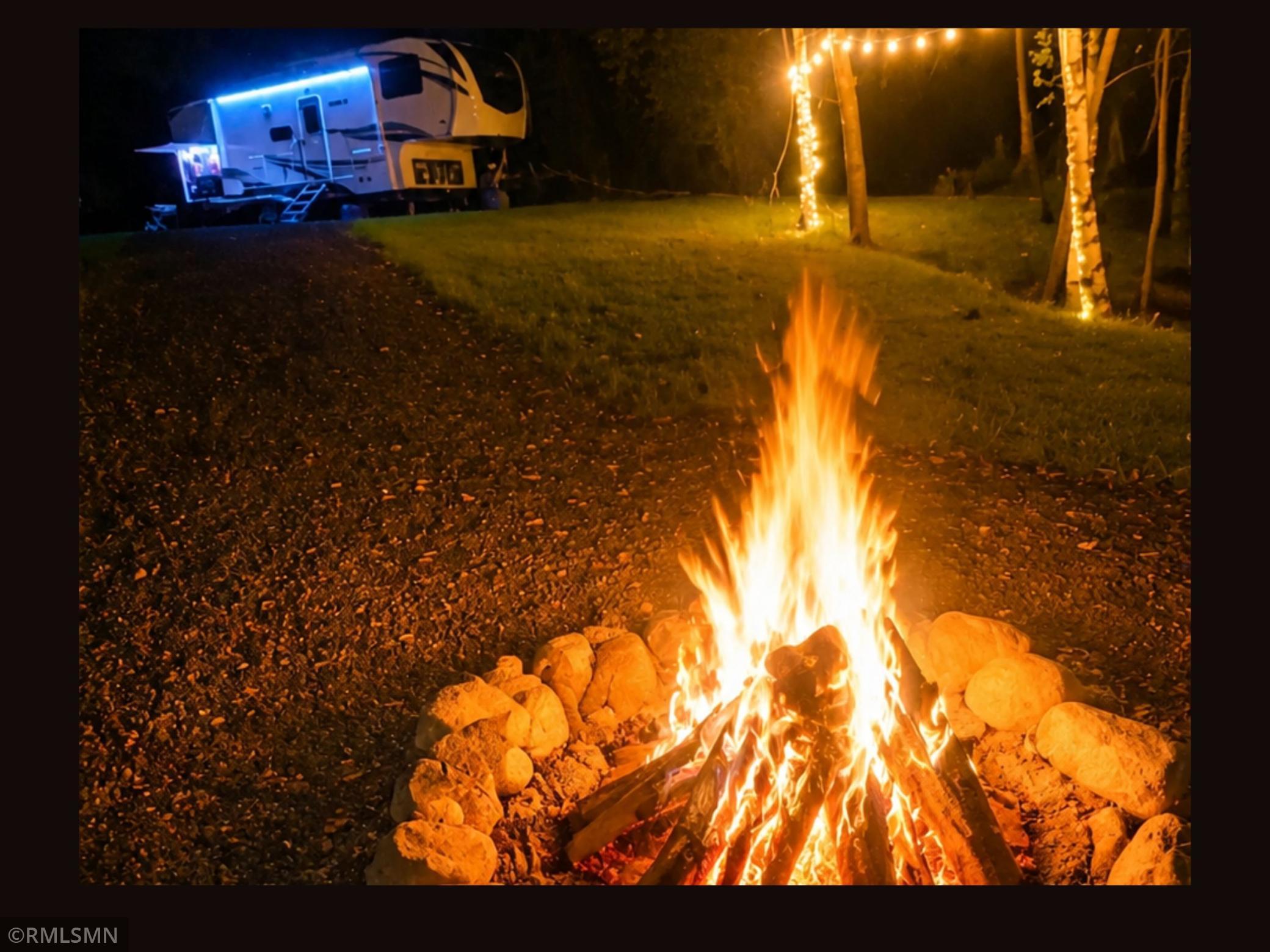 RV parked with campfire going