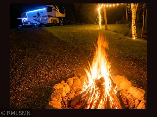 RV parked with campfire going