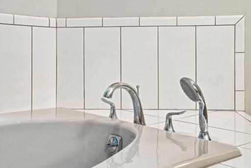 The jetted tub offers a comfortable place to unwind in the primary suite.