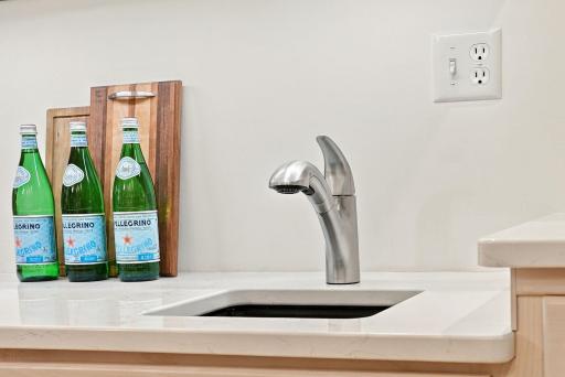 A dedicated bar sink adds everyday convenience to the kitchen.