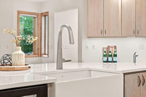 Custom hardware and quartz countertops complete this beautiful design.