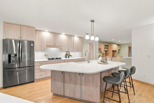 The oversized island offers plenty of room for preparation, serving, and casual seating.