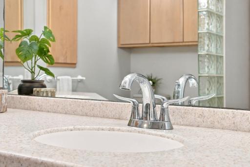An oversized double vanity offers exceptional storage and preparation space.