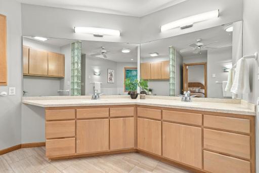 Dual vanities and extensive counter space support comfortable everyday routines.