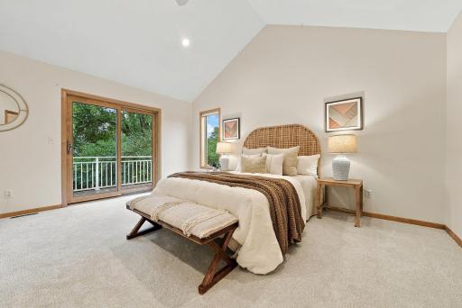 The spacious primary bedroom opens directly to a private upper-level deck.