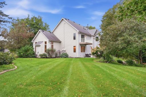Mature trees frame the home and add to the privacy of the backyard.