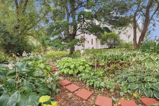 Beautifully maintained garden beds enhance the home’s private outdoor setting.