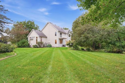 A broad lawn provides exceptional open space within the landscaped property.