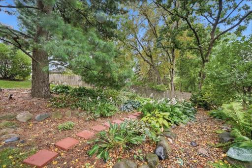 Layered landscaping brings texture, color, and privacy to the backyard.