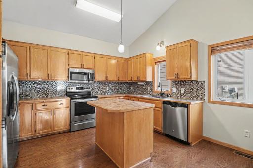 Kitchen with center island, stainless steel appliances, and built-in buffet.
