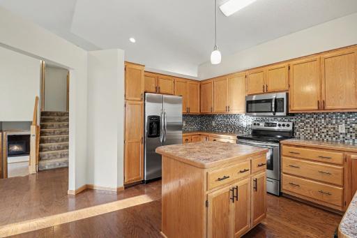 Kitchen view highlighting the stainless steel appliances and center island.