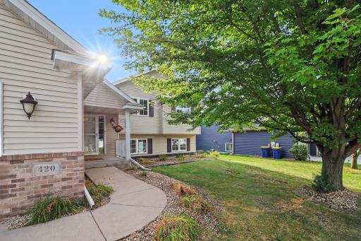 Curved front walk leading to the covered entry.