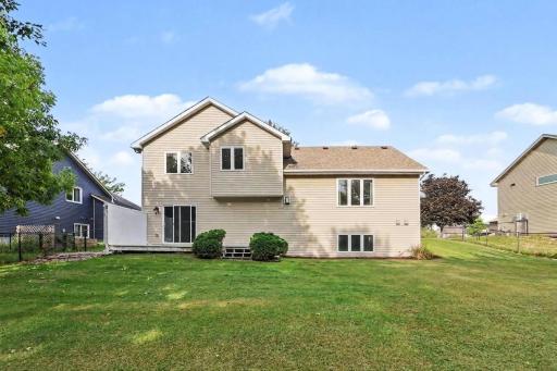 Rear exterior view with walkout access and fenced yard.