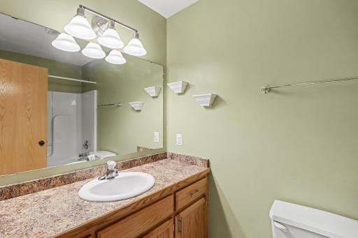 Lower-level three-quarter bath with vanity and shower.