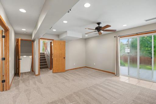 Lower-level family room with fresh carpet and flexible gathering space.