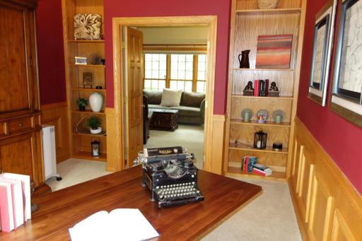 The office has floor to ceiling bookshelves.
