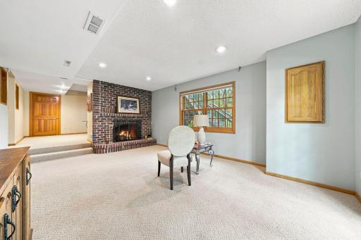 Lower level family room with brick firepace.