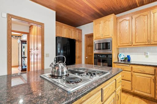 The center island has a JennAir electric cooktop.
