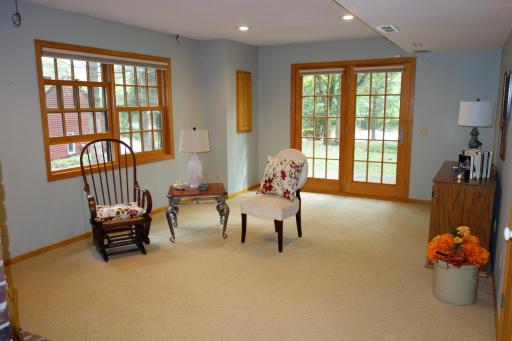 Walk-out lower level family room with brick fireplace, new Marvin patio doors, an exposed aggregate patio that all leads to a large flat yard.