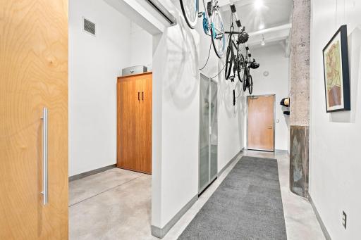 Welcome to unit #405. This is the hallway with views of the den, which has a convenient Murphy bed enclosure for guests.